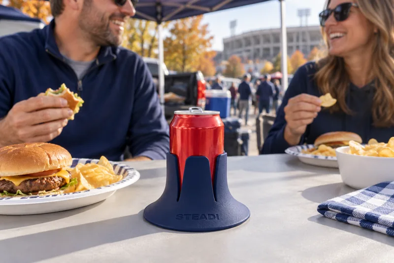 An opened can in Navy Steadi beside a tailgate lunch. AI lifestyle illustration.